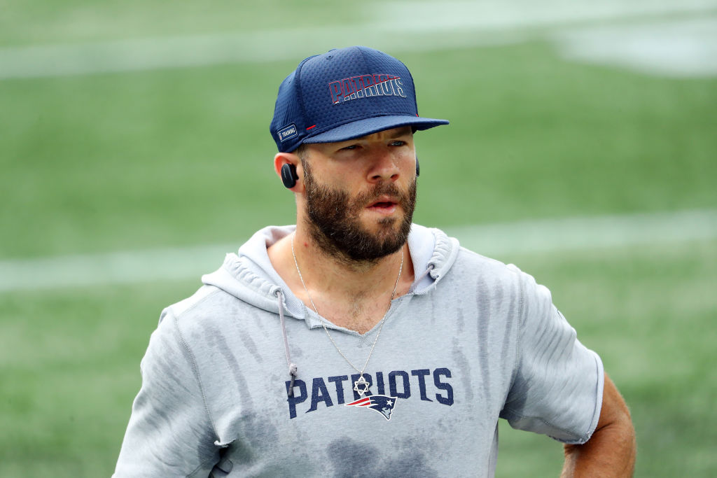 Julian Edelman in a Patriots cap in a hoodie with sweat dripping