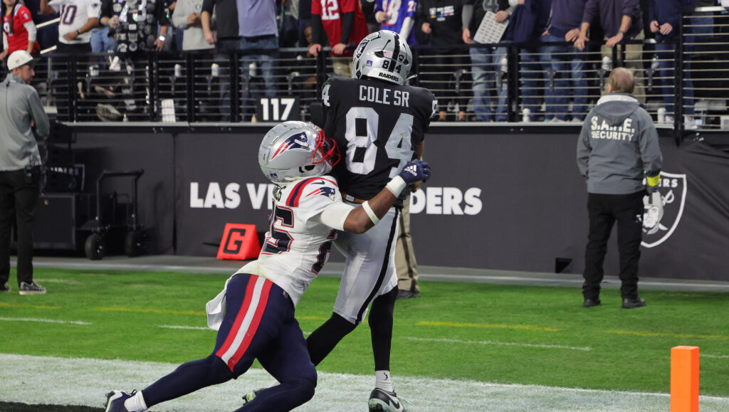 Raiders wideout Keelan Cole catches a touchdown pass with a Patriots defender on him.