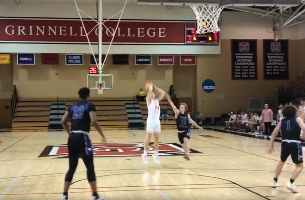 college basketball player shooting a three-pointer