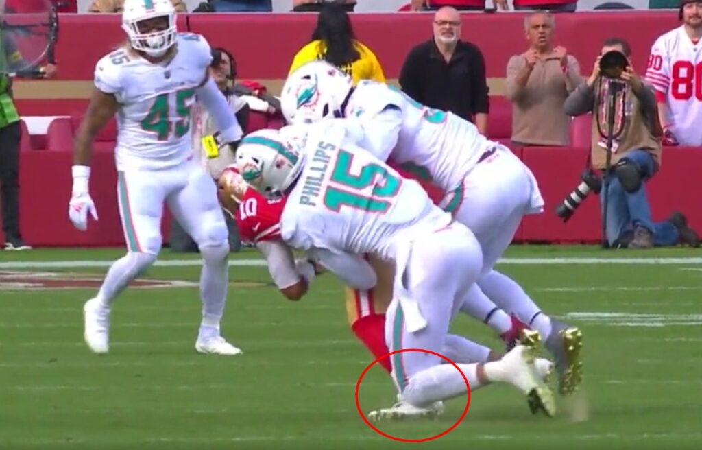 Jimmy Garoppolo getting tackled by two Miami defenders and having his left foot injured for week 14 injury report
