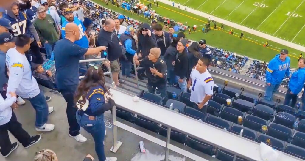 Chargers fans confront each other in the stands.