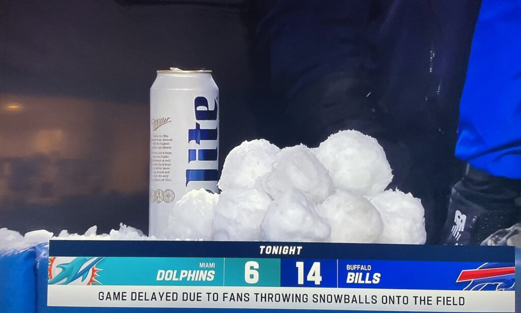 A pile of snowballs with a beer is captured by cameras during the BIlls-Dolphins game.