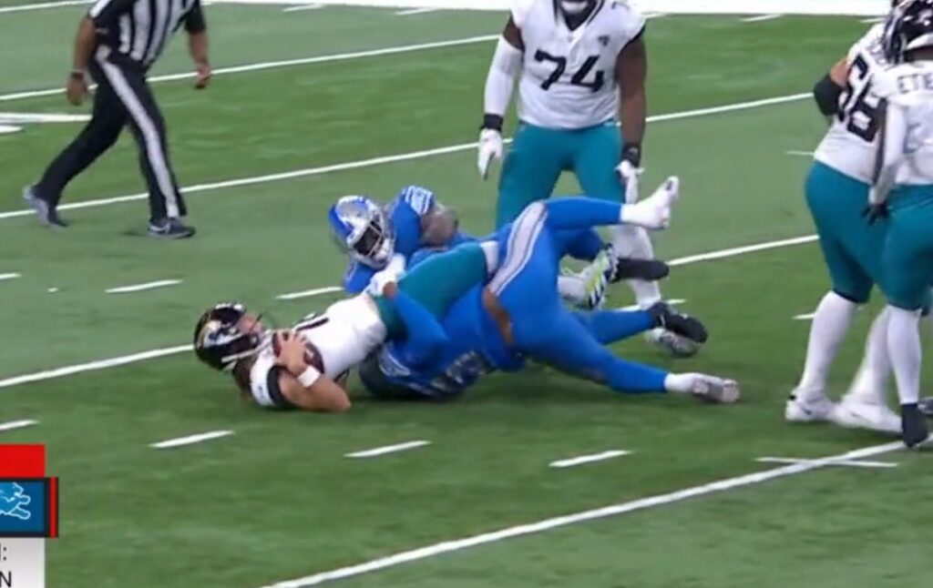 Trevor Lawrence getting sacked by two defenders and injured in game vs the Detroit Lions