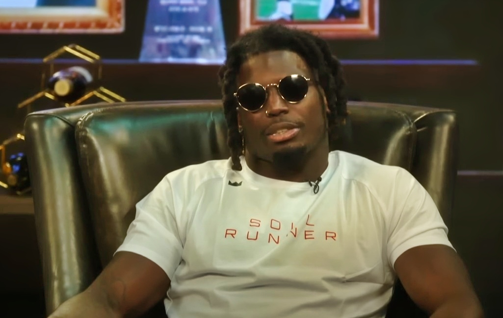 Tyreek Hill in sunglasses while sitting on chair 