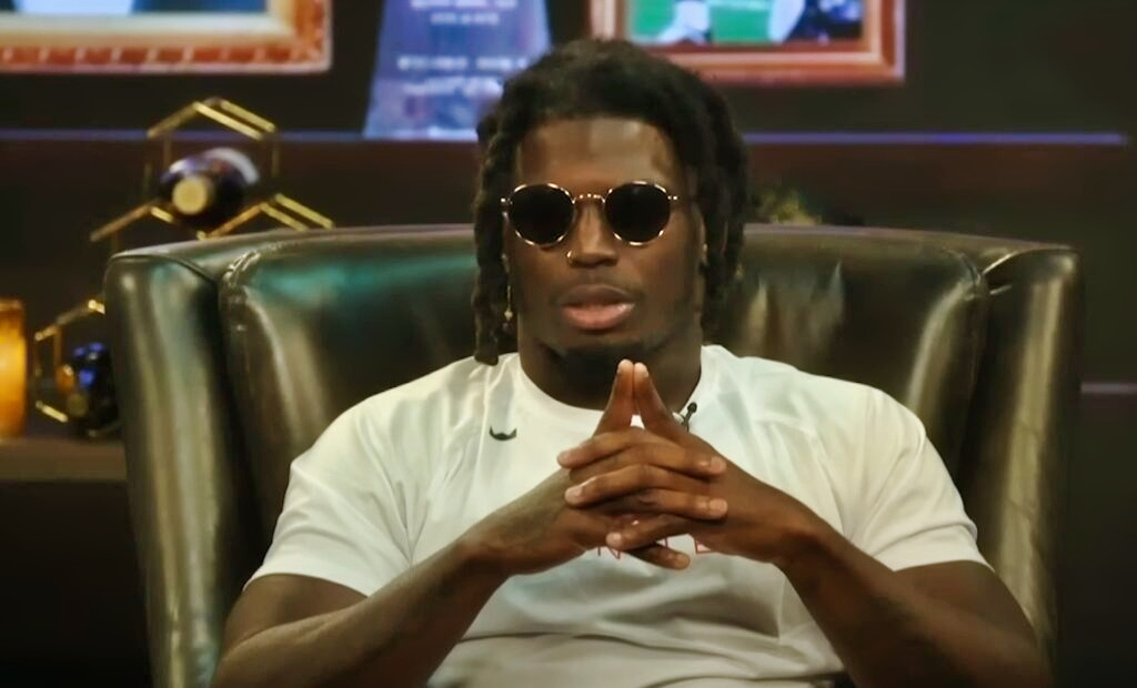 Tyreek Hill with his hands touching while sitting