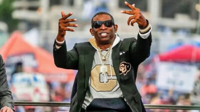 New Colorado head coach Deion Sanders posing after appointment