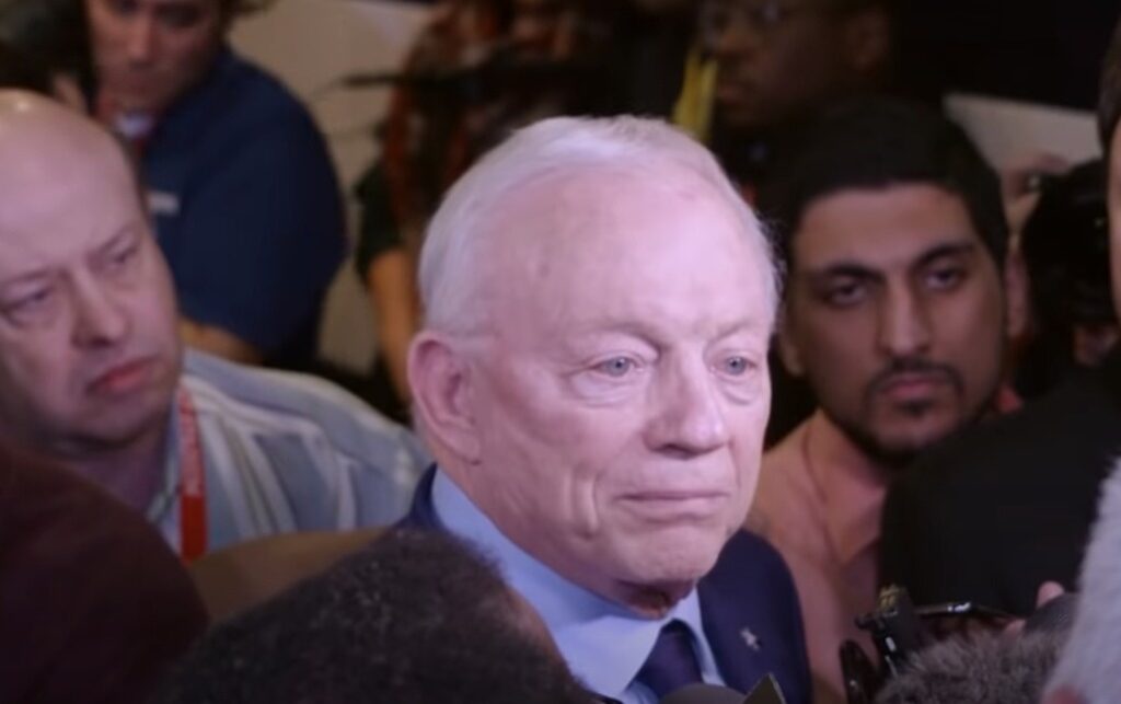 Jerry Jones surrounded by reporters