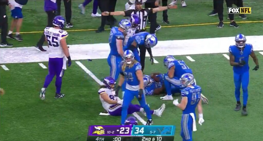 Lions and Vikings players walk off following the final play of the game.