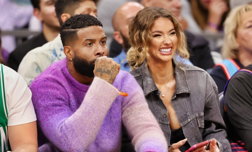 Odell Beckham Jr. and Lauren Wood sitting courtside at basketball game