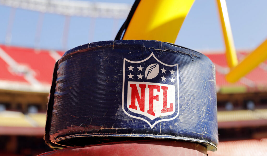 The NFL logo on a field goal post.
