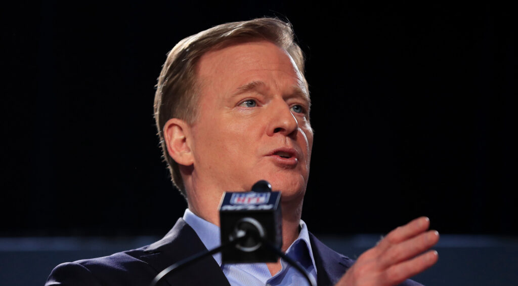 Roger Goodell talks into a microphone.