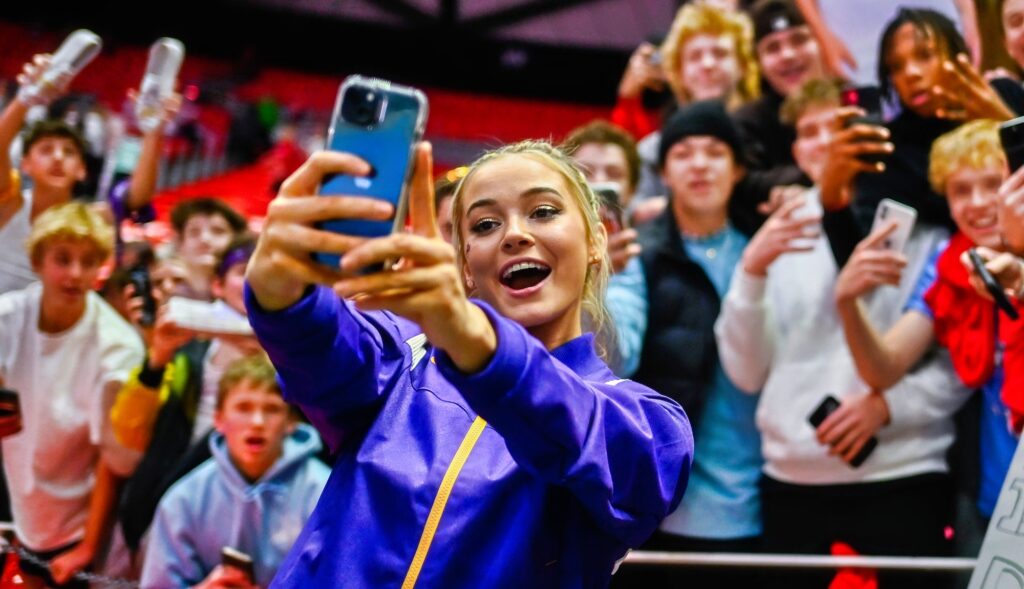 Olivia Dunne takes a selfie with fans.