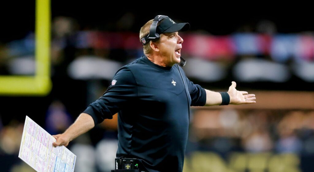 Sean Payton holds his arms out while questioning a call.