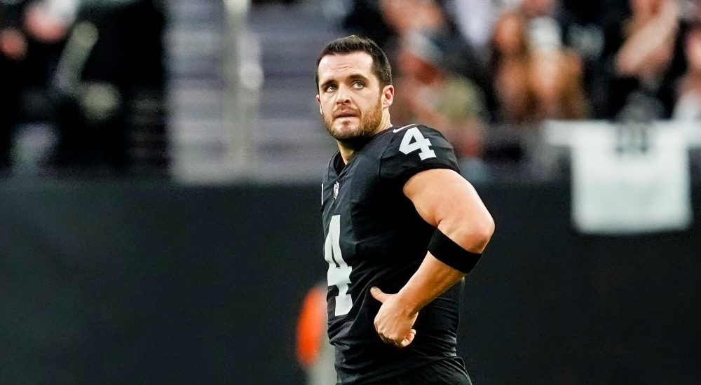 Derek Carr with his hand on his waist
