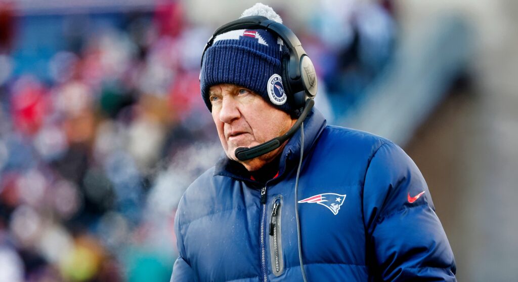 Bill belichick in Patriots coat and headset on head