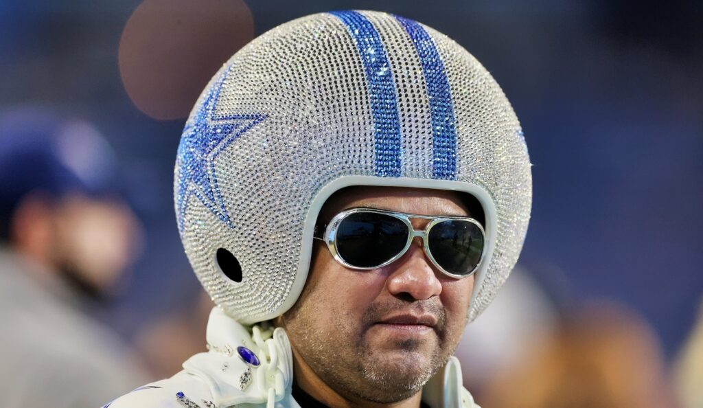 Dallas Cowboys fan wears giant diamond-filled helmet.
