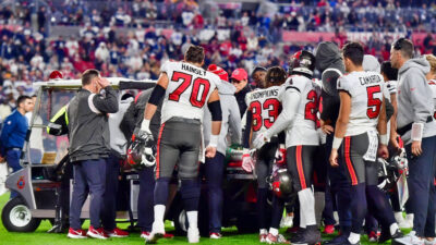 Buccaneers players observing Russell Gage after he suffers frightening injury
