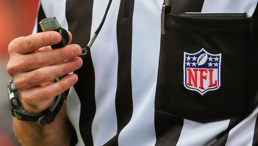 NFL ref with whistle in hand