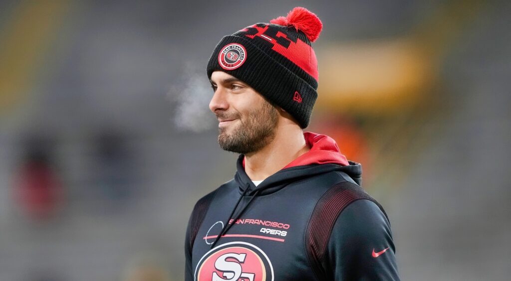 San Francisco 49ers quarterback Jimmy Garoppolo looking on and smiling.