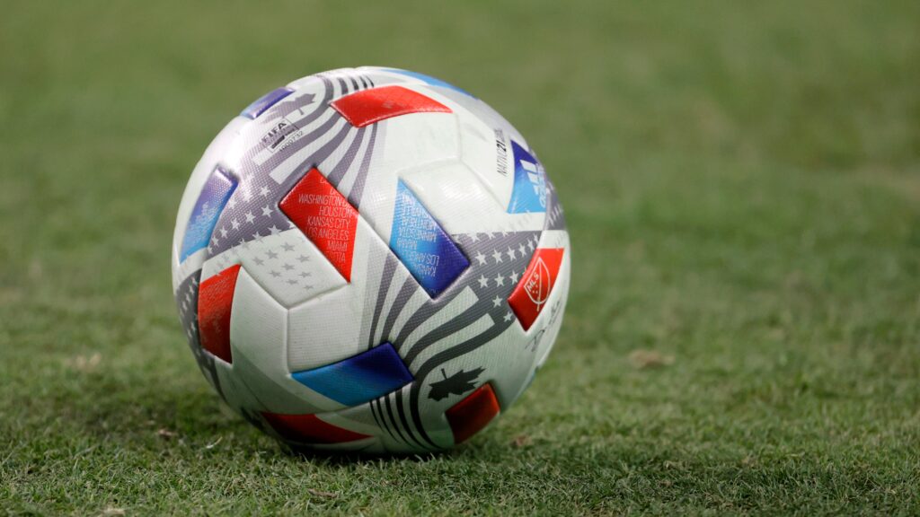 An MLS Soccer ball on the pitch.