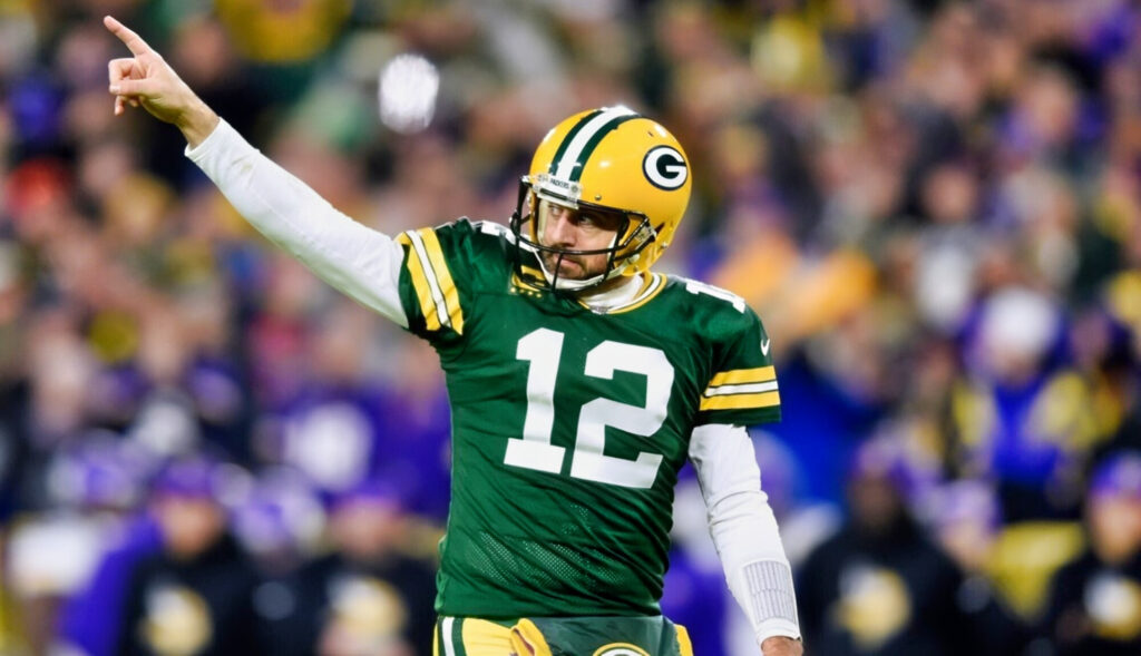 Green Bay Packers quarterback Aaron Rodgers celebrates after throwing touchdown.