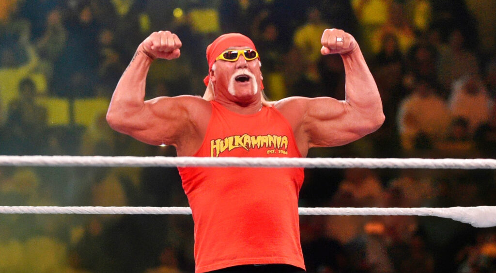 Hulk Hogan flexing his biceps in a wrestling ring