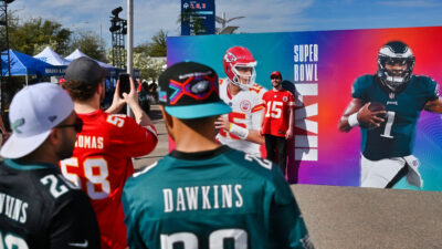 Eagles and Chiefs fans taking photos outside the State Farm Stadium in Arizona ahead of Super Bowl 57