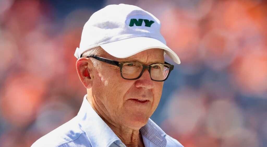 Jets owner Woody Johnson on the field before a game.