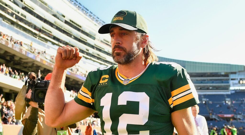 Aaron Rodgers pumps his fist while walking off the field.