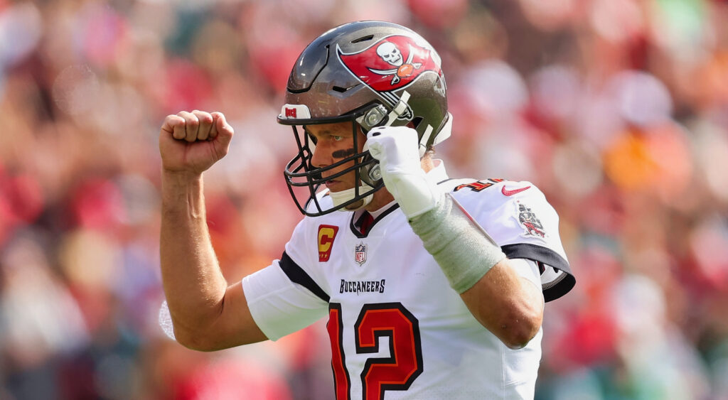 Tampa Bay Buccaneers quarterback Tom Brady celebrating a Giovani Bernard touchdown by raising arms in the air.