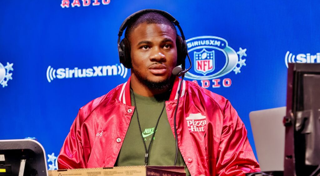 Micah Parsons dose an interview at a table for Sirius XM.