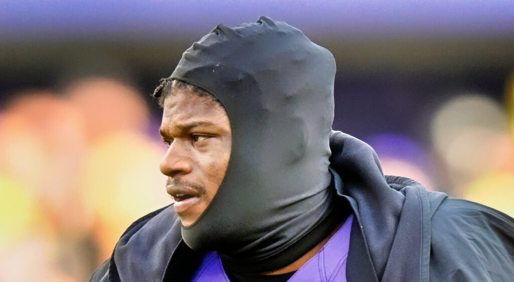Baltimore Ravens quarterback Lamar Jackson looking on during game.