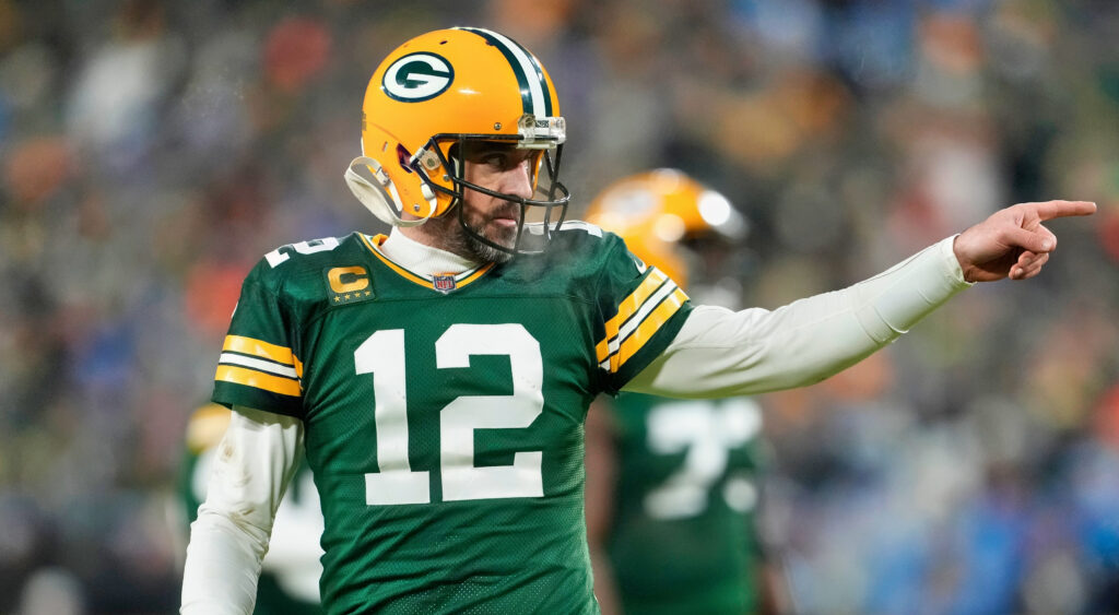 Green Bay Packers quarterback Aaron Rodgers points to celebrate after throwing a touchdown.