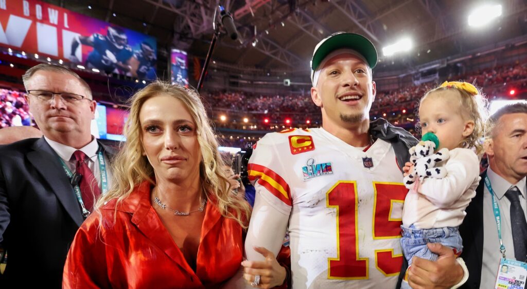 Brittany and Patrick Mahomes walk off the field after the Chiefs' Super Bowl win.