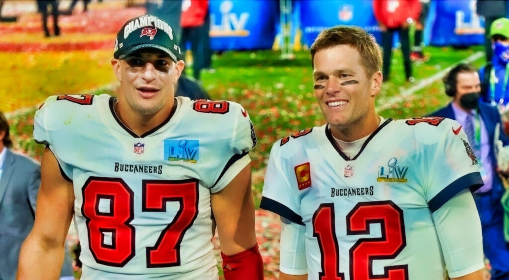 Rob Gronkowski (left) and Tom Brady (right) smiling after winning Super Bowl 55.