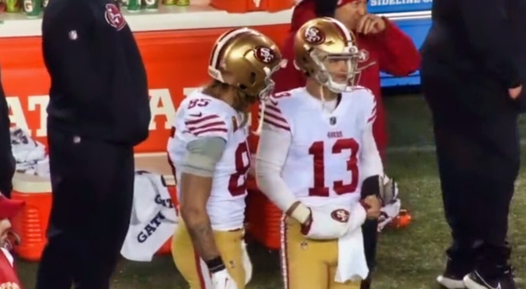 George Kittle and Brock Purdy on sidelines in uniforms