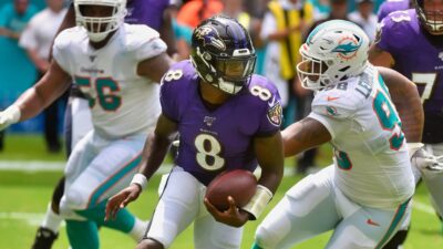Lamar Jackson running with a football vs. Miami Dolphins