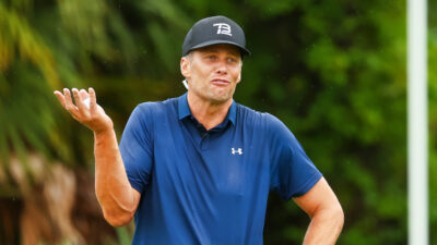 Tom Brady gesturing on a golf course