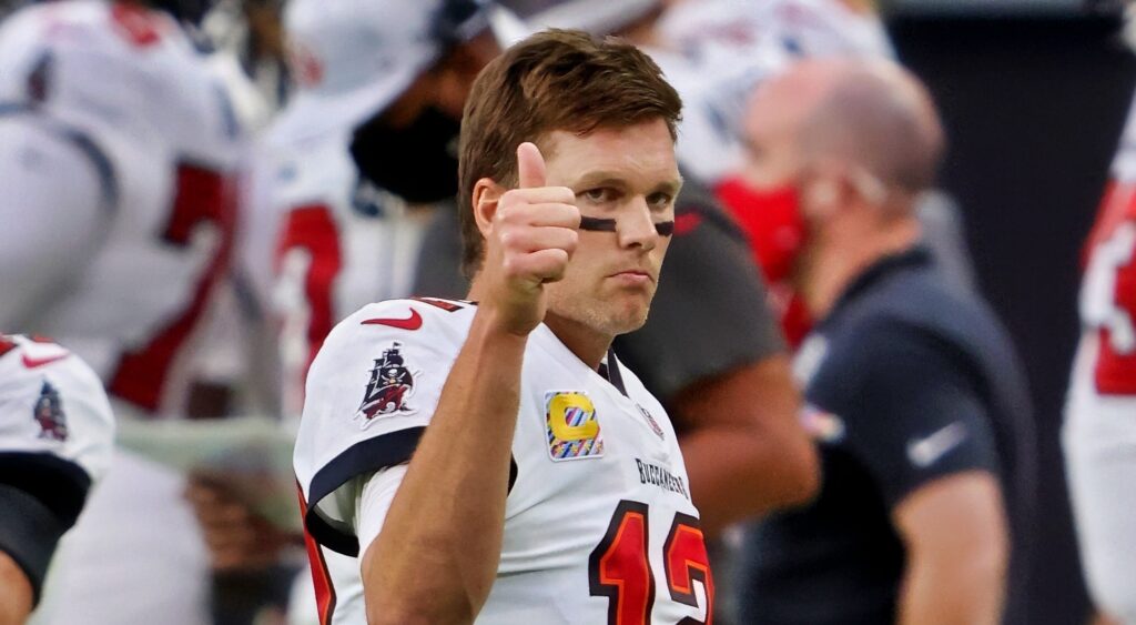 Tom Brady in Bucs uniform while holding a thumb up