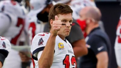 Tom Brady in Bucs uniform while holding a thumb up