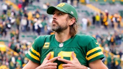Aaron Rodgers looking up with no helmet on