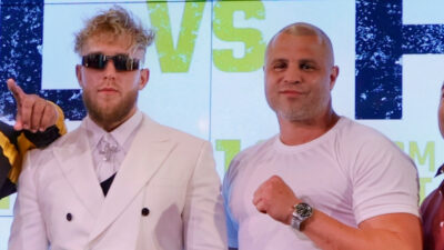 Jake Paul standing next to trainer BJ Flores