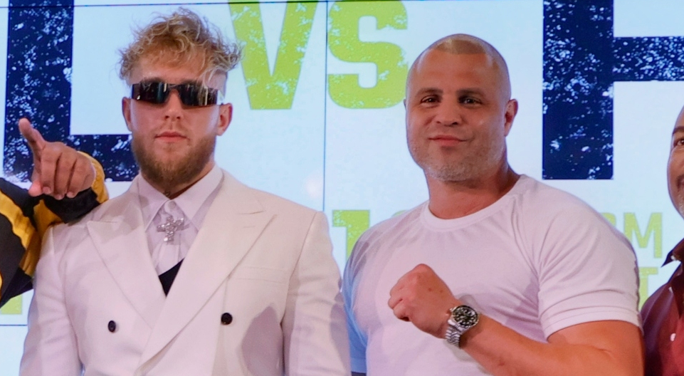 Jake Paul standing next to trainer BJ Flores