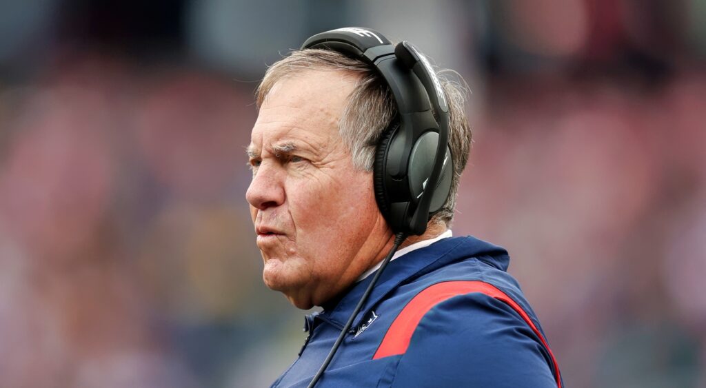 New England Patriots head coach Bill Belichick with headset on and Pats gear