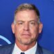 Troy Aikman posing in gray suit