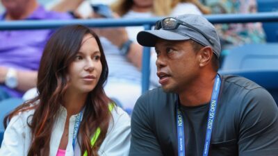 Tiger Woods in stands with Erica Herman