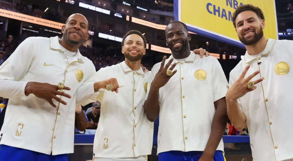 Golden State Warriors players showing their 2022 championship rings.