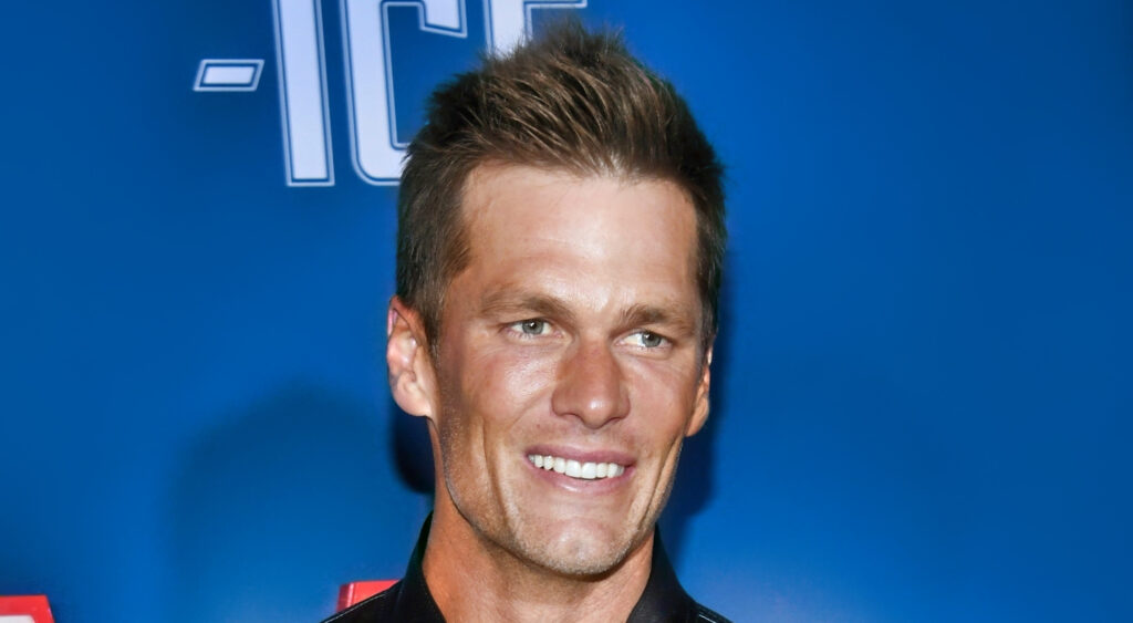 Tom Brady smiling at "80 For Brady" premiere.