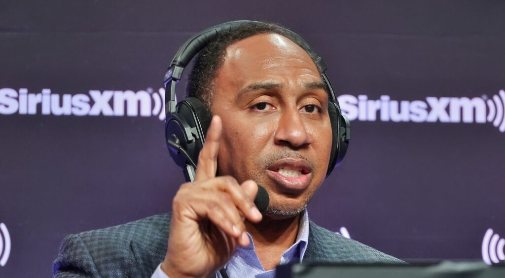 Stephen A. Smith with headset on and pointing his finger