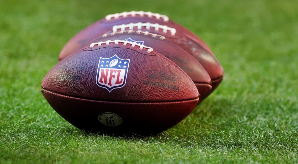NFL footballs on grass
